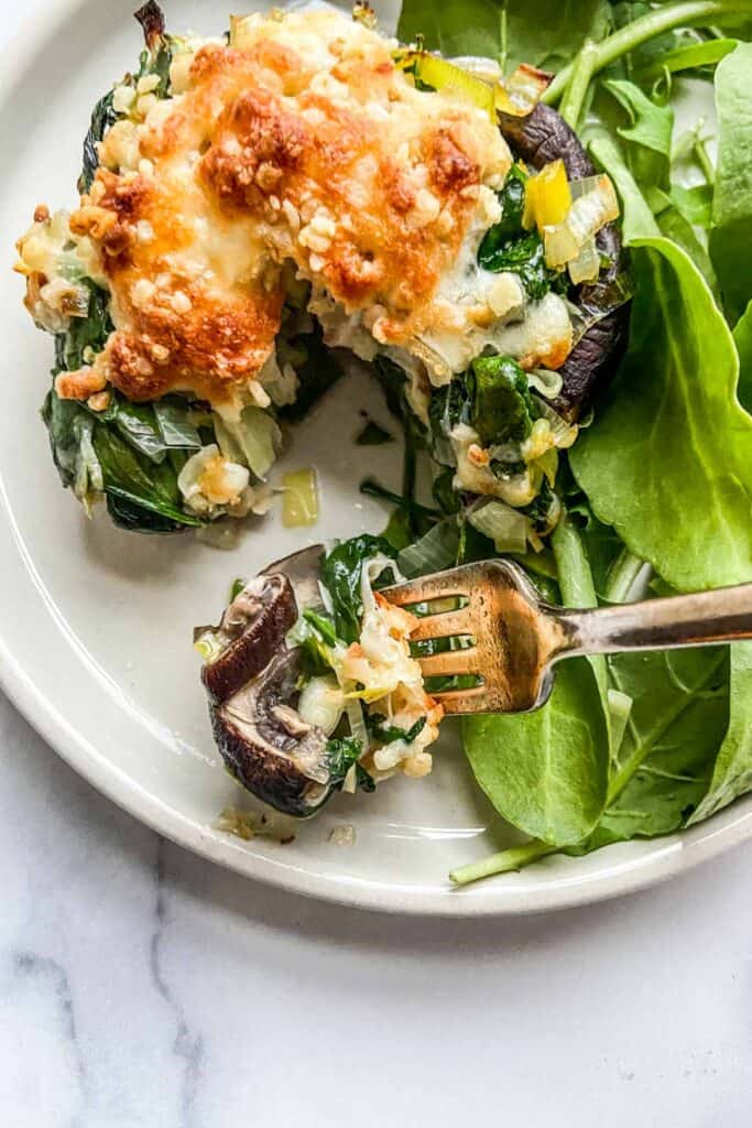 portobello mushroom on a plate with a green salad