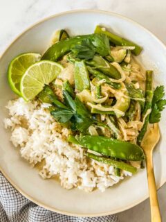 Vegetarian Thai Green Curry in a white bowl with a fork.