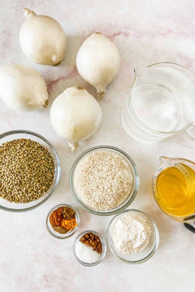 Ingredients for mujaddara - including onions, lentils, rice, oil, water, and spices.