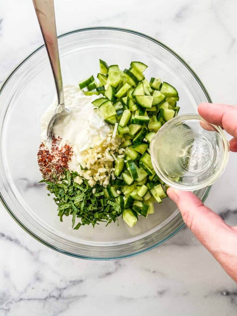 Ingredients for minted yogurt in a mixing bowl.