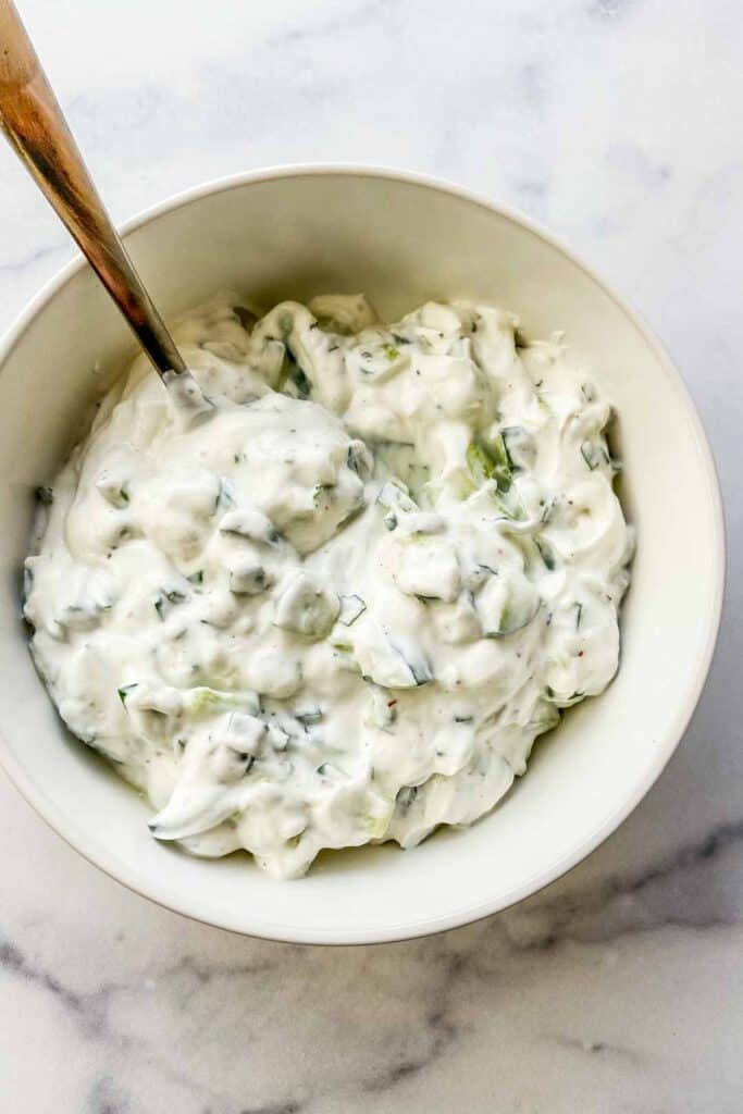 A bowl of yogurt cucumber sauce. 