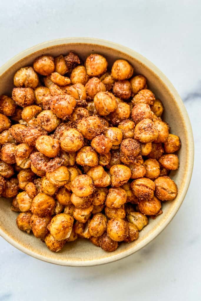 A closeup shot of a bowl of roasted chickpeas.