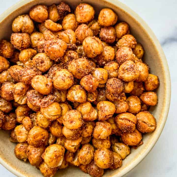 A closeup shot of a bowl of roasted chickpeas.