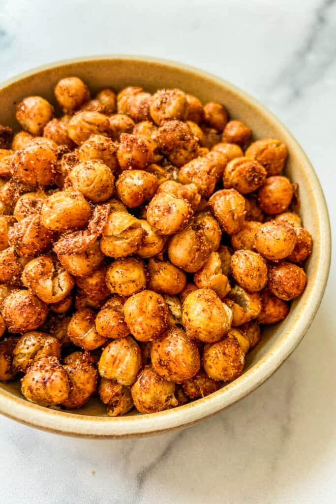 A closeup shot of a bowl of roasted chickpeas.