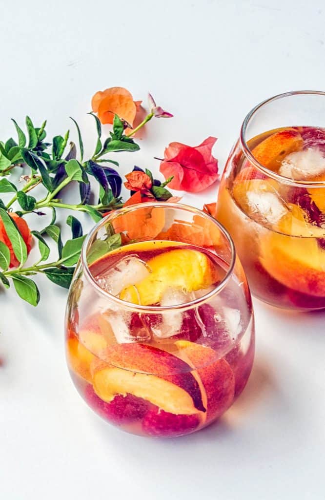 peach and raspberry sangria in wine glasses
