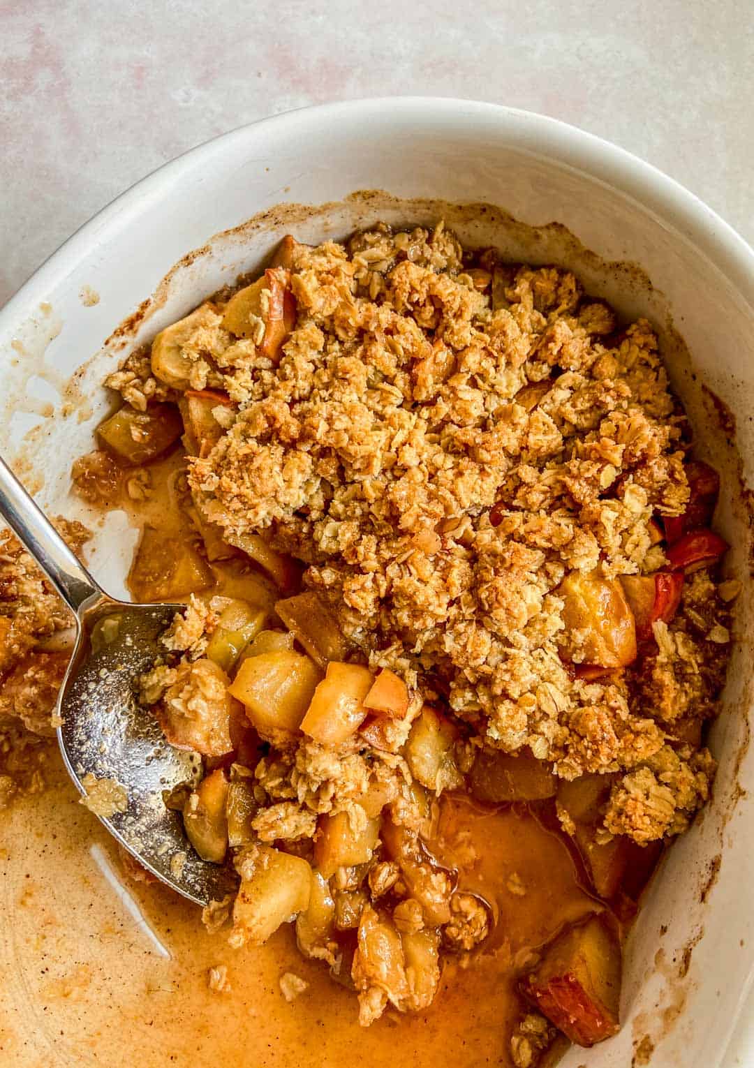 A caramelized apple crisp in a baking dish.