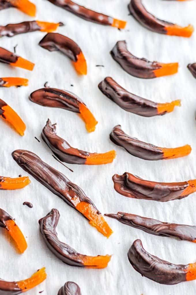 dark chocolate covered clementine peels on parchment
