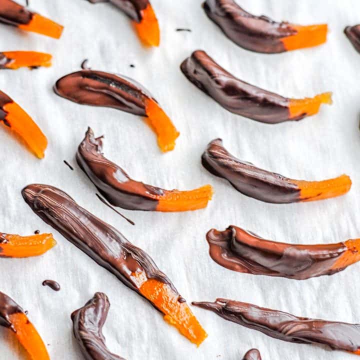 dark chocolate covered clementine peels on parchment