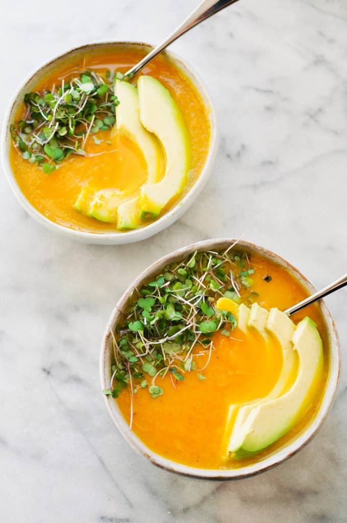 bell pepper soup with carrots - topped with microgreens and avocado