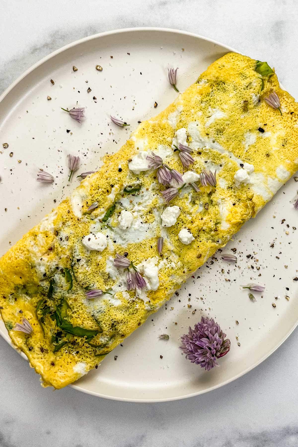 Spring asparagus omelet on a white plate.