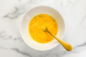 Whisked eggs in a bowl.
