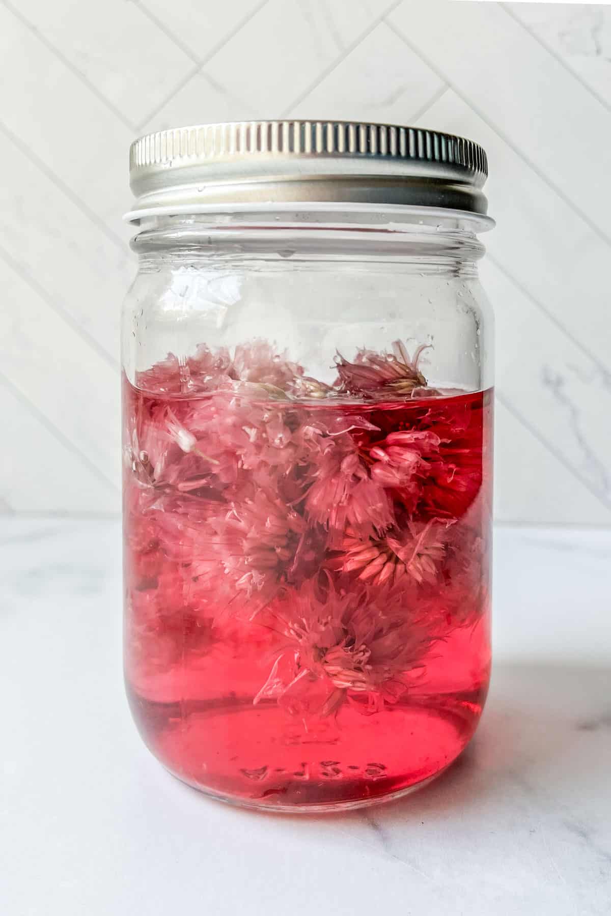 A bottle of chive blossom vinegar.