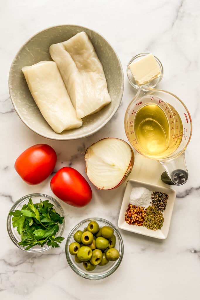 Sea bass, roma tomatoes, white wine, butter, onion, spices, parsley, and olives.