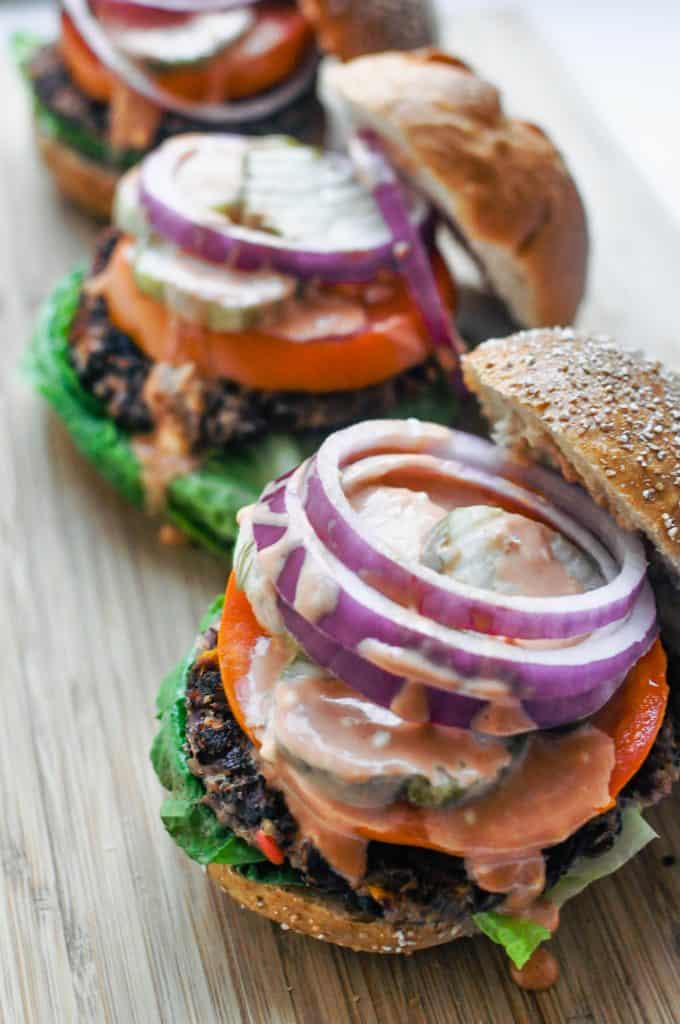 black bean burgers open - displaying onions and condiments
