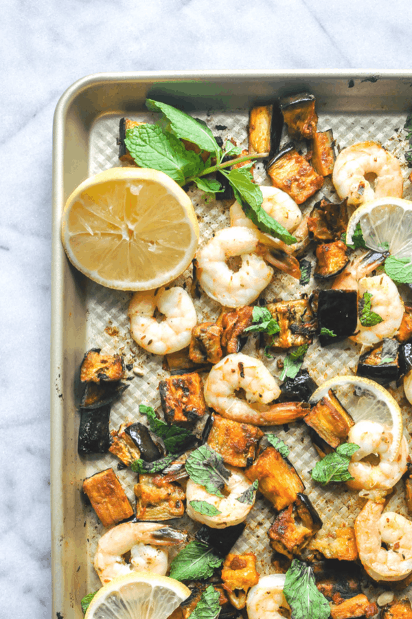 Roasted eggplant and shrimp on a baking sheet.