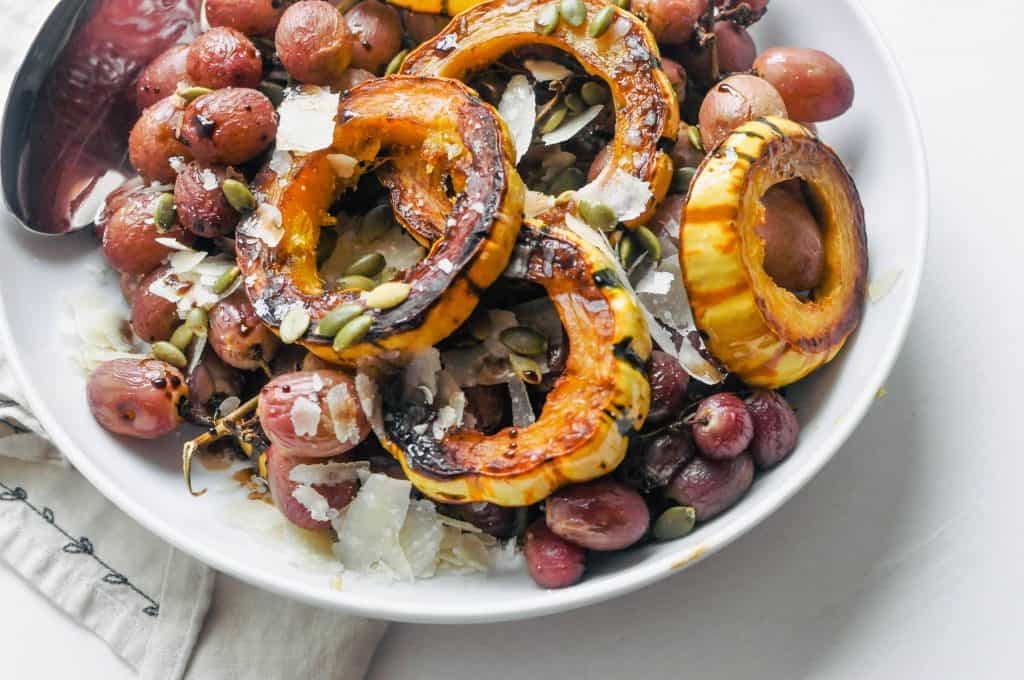 roasted squash and grapes in a serving bowl