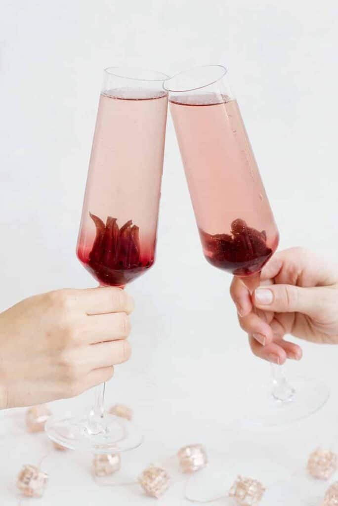 Ombre hibiscus cocktails in champagne glasses.