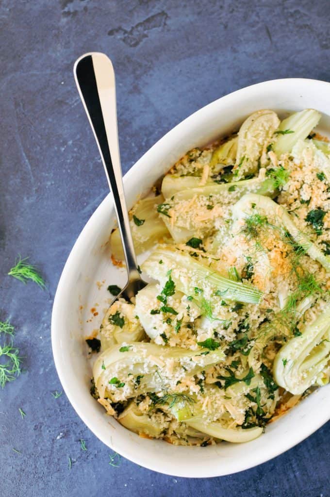 fennel gratin in a baking dish with a serving spoon