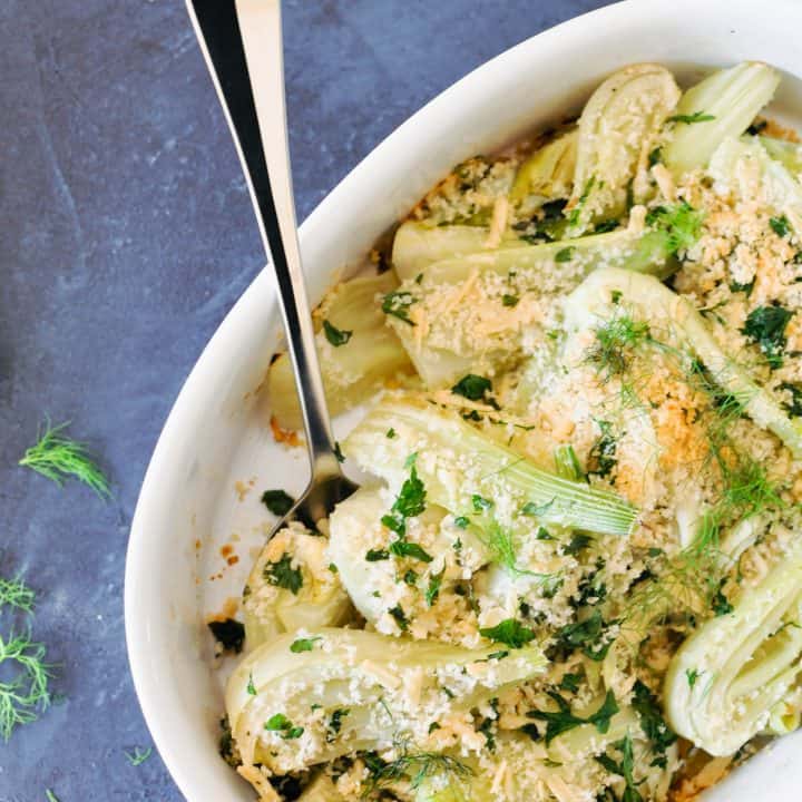 fennel gratin in a baking dish with a serving spoon
