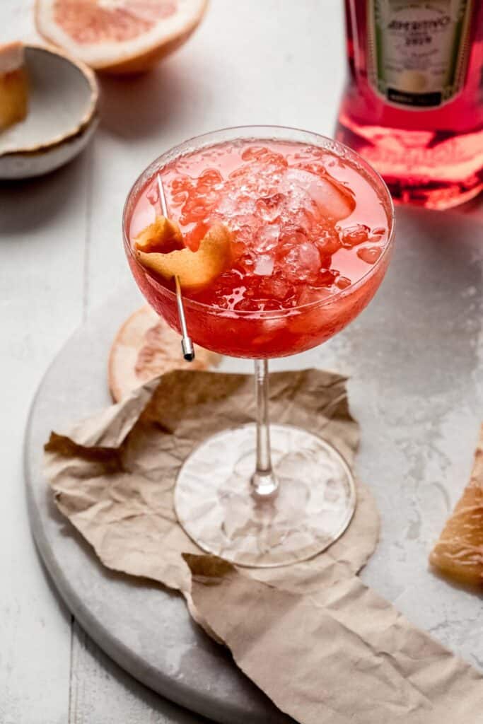 Grapefruit aperol cocktail in a glass with a twist.