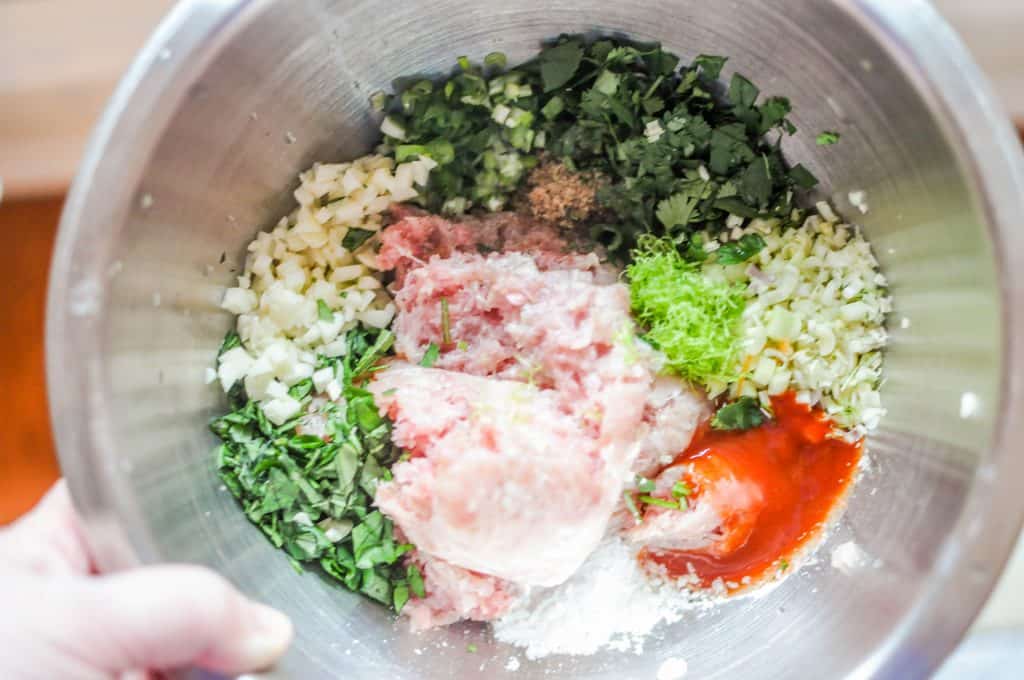 mixing bowl with ground turkey, garlic, and herbs