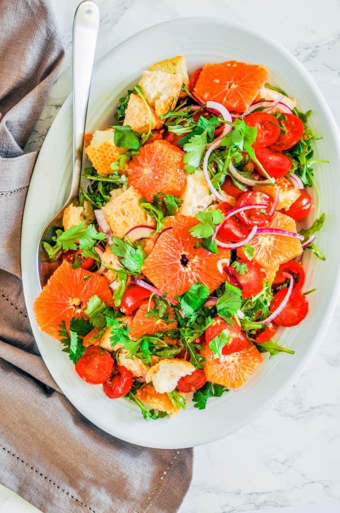 overhead shot of citrus panzanella on a platter