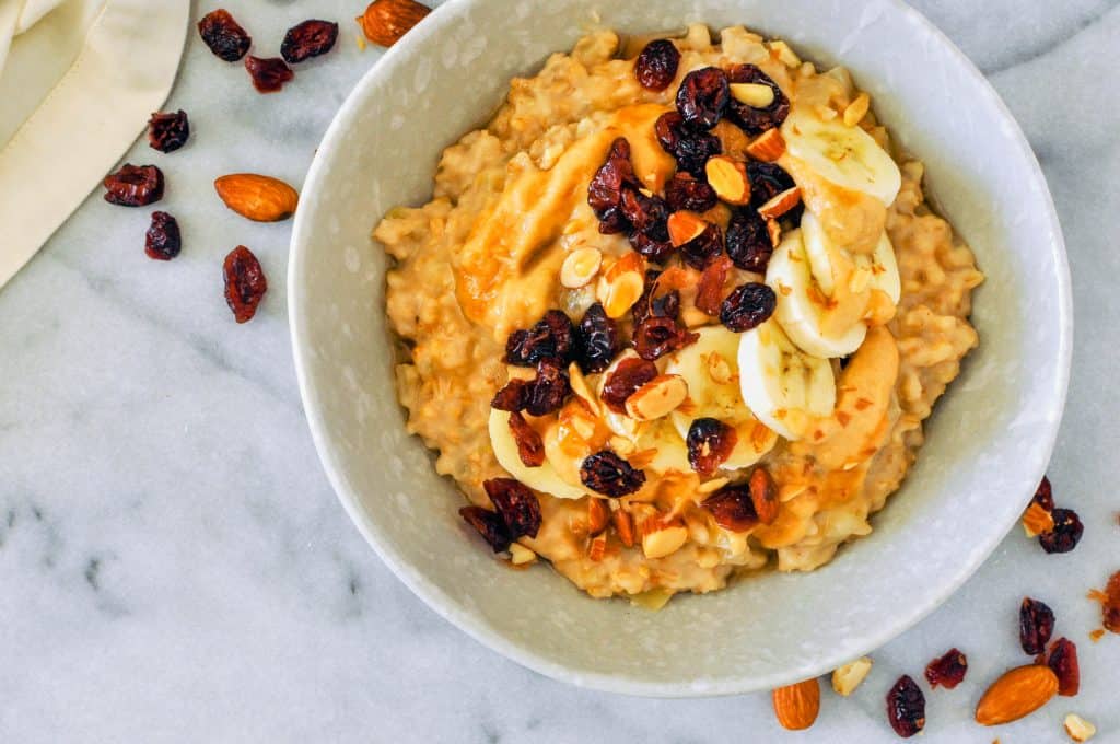 oatmeal in a bowl, topped with dried fruit