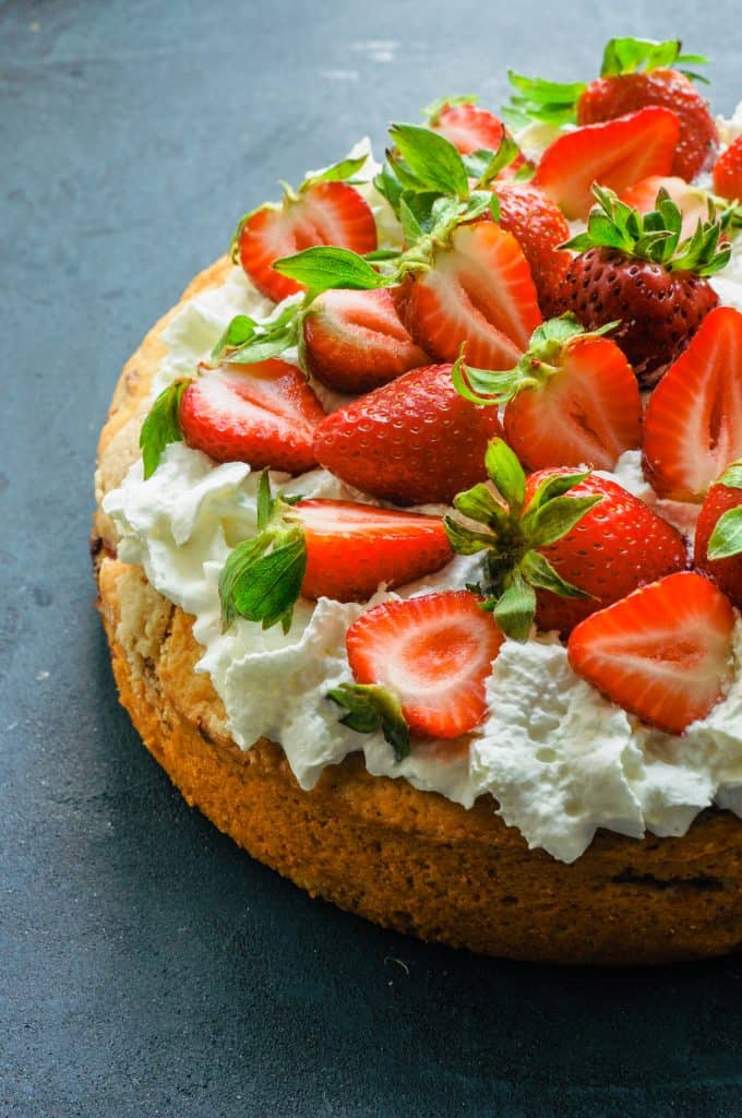 strawberry tahini shortcake topped with whipped cream and fresh berries