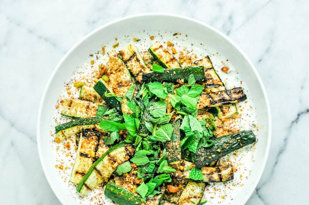 roasted zucchini on yogurt, topped with herbs