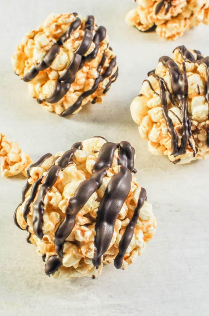 popcorn balls with chocolate drizzle