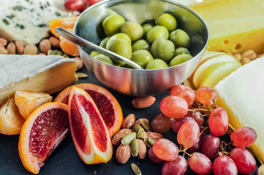 closeup of blood oranges and green olives