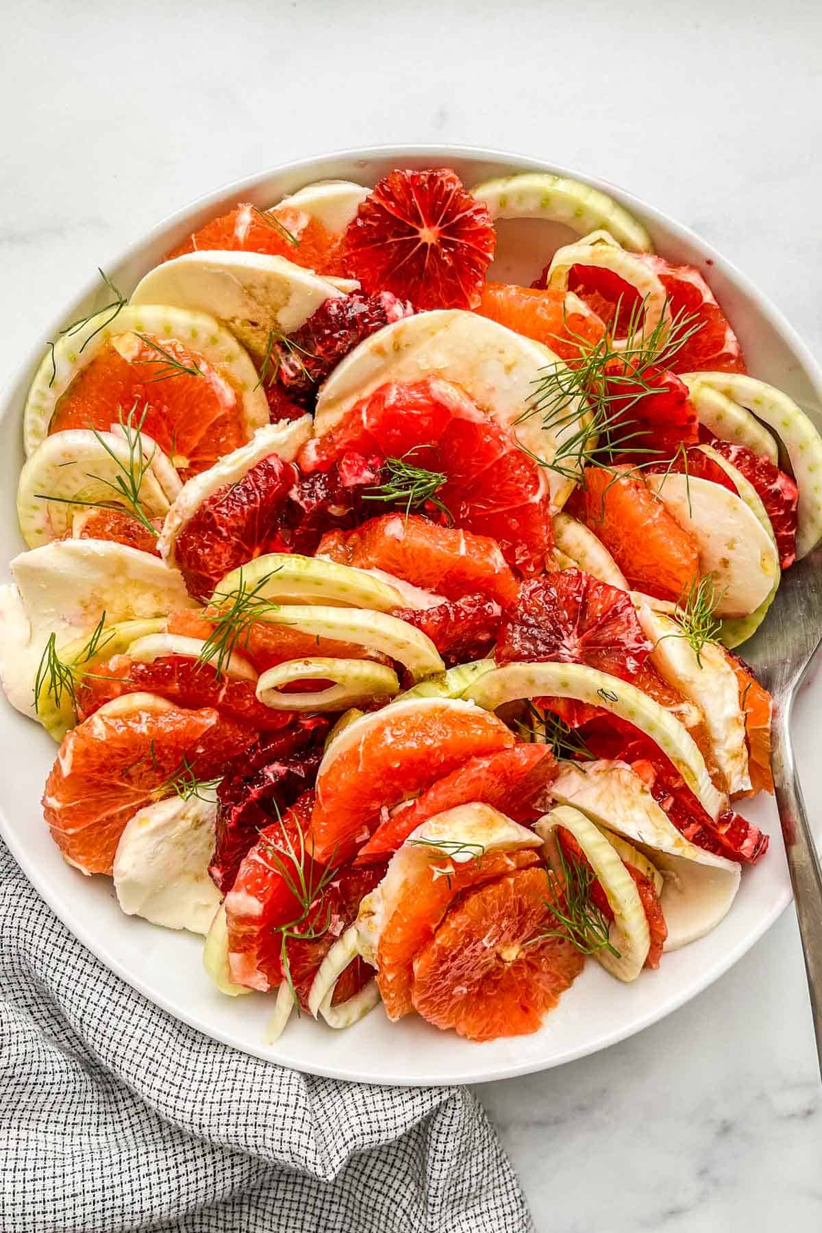 A citrus fennel and mozzarella salad in a serving bowl.