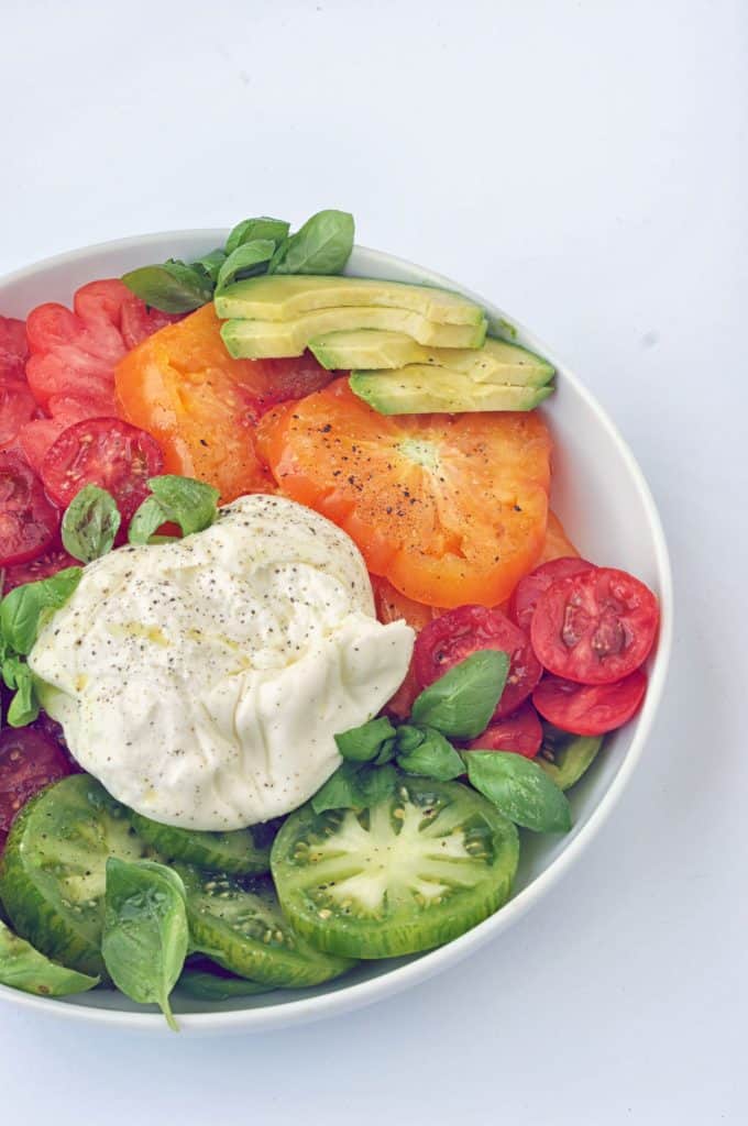 burrata caprese salad recipe on a plate
