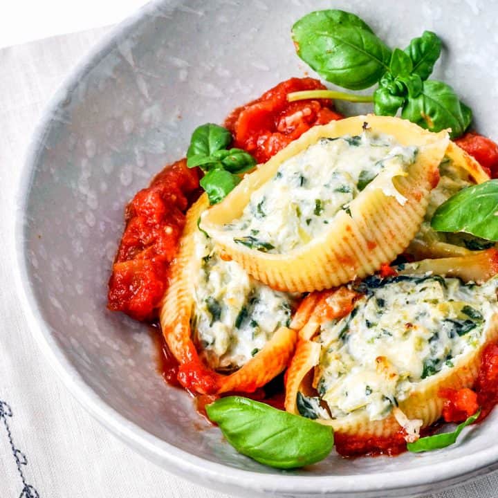 spinach artichoke stuffed pasta shells in a bowl