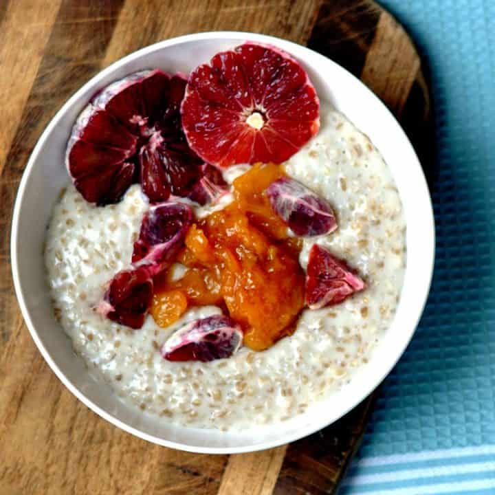 steel cut oats in a bowl with blood oranges and peach compote topping