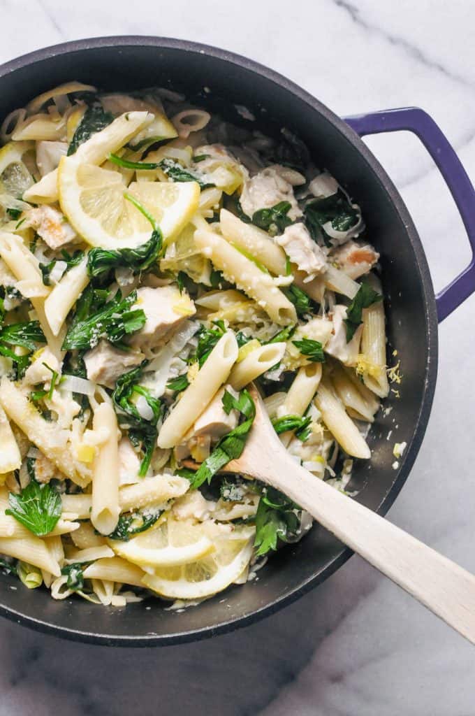 Lemon chicken pasta in a blue dutch oven.