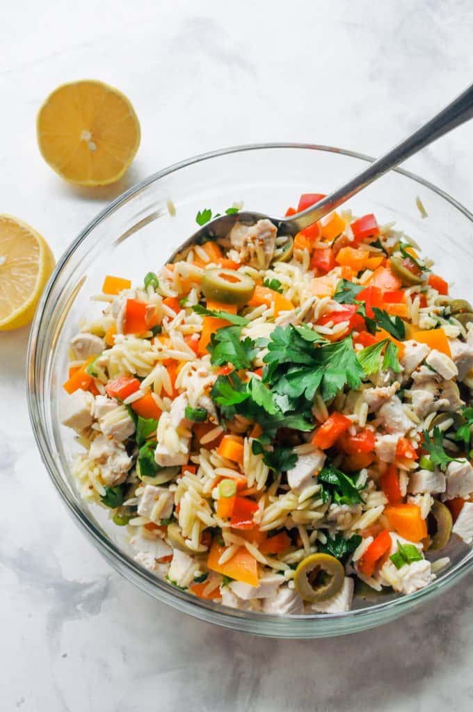 Orzo chicken salad pasta in a glass bowl.