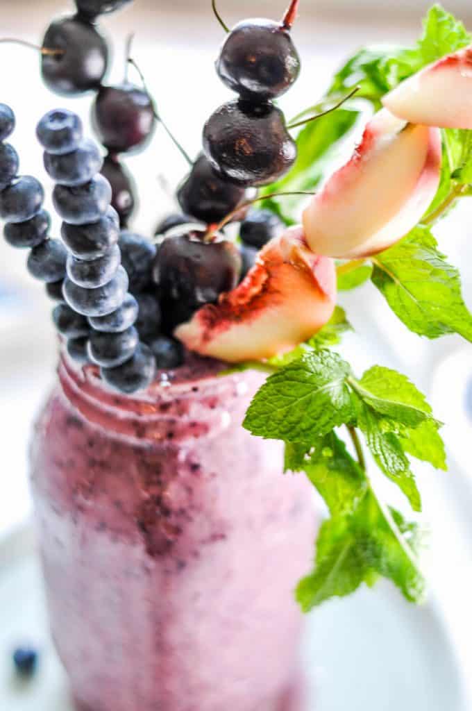 freakshake in a ball jar with skewers of fruit