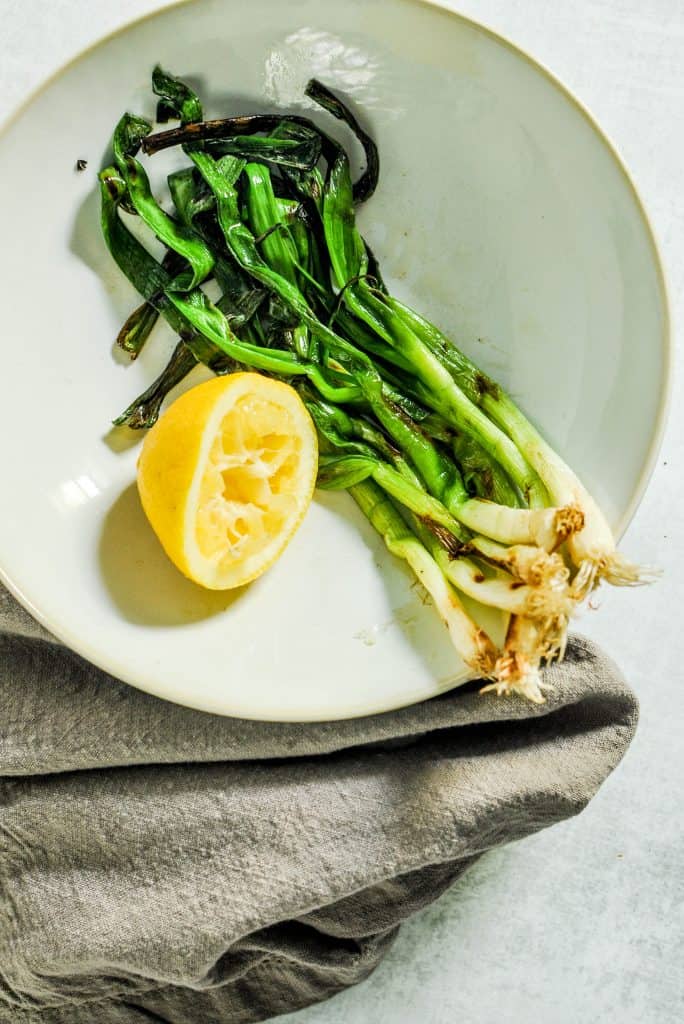 grilled scallions in a bowl