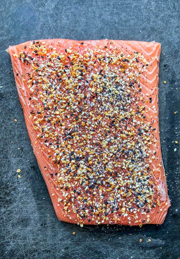 salmon with everything bagel seasoning on a cutting board