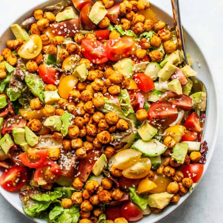 Roasted chickpea salad in a large white serving bowl.