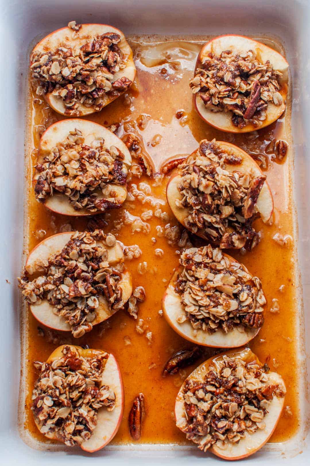 Baked apples with oatmeal in a casserole dish.