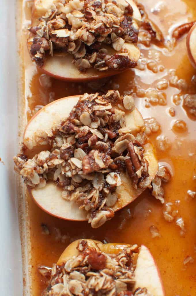closeup of baked apple topped with oatmeal and nuts mixture