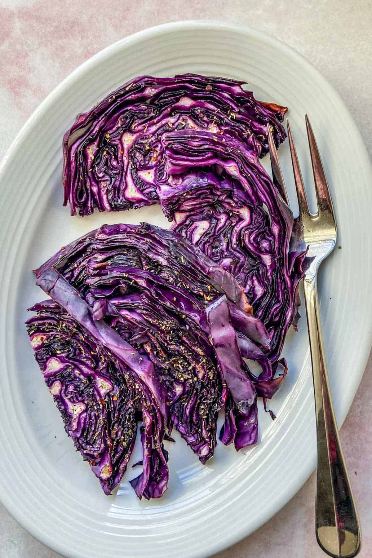 Roasted purple cabbage on a white serving platter.