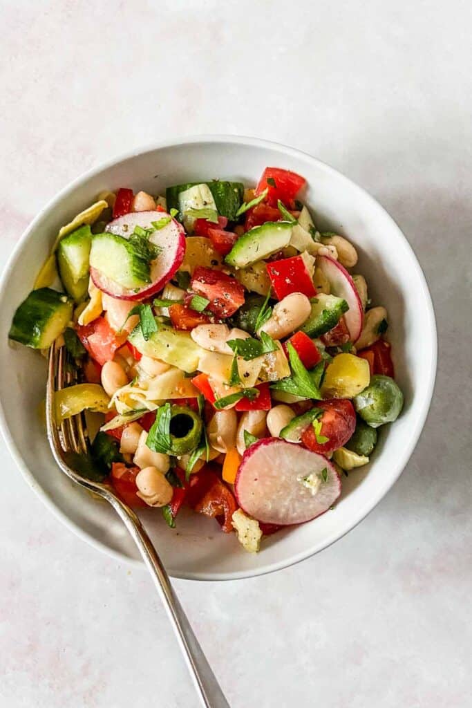bean salad in a small bowl with a fork