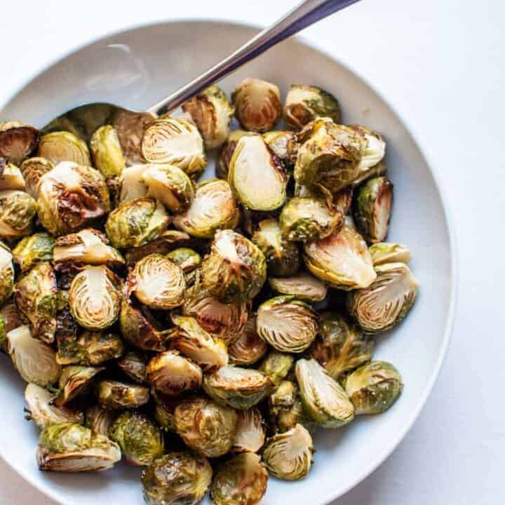 roasted brussels sprouts in a white serving bowl