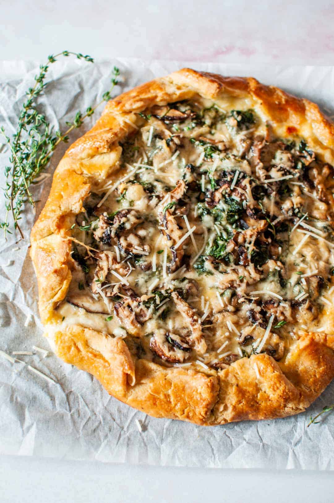 savory mushroom galette on a piece of parchment paper