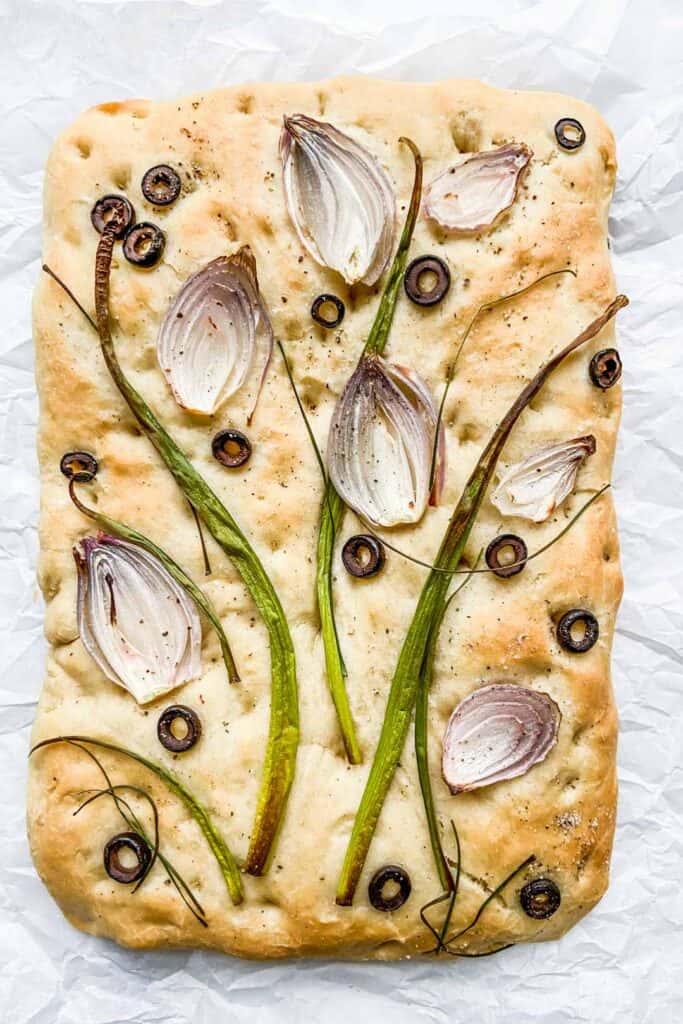 decorated focaccia on a piece of parchment