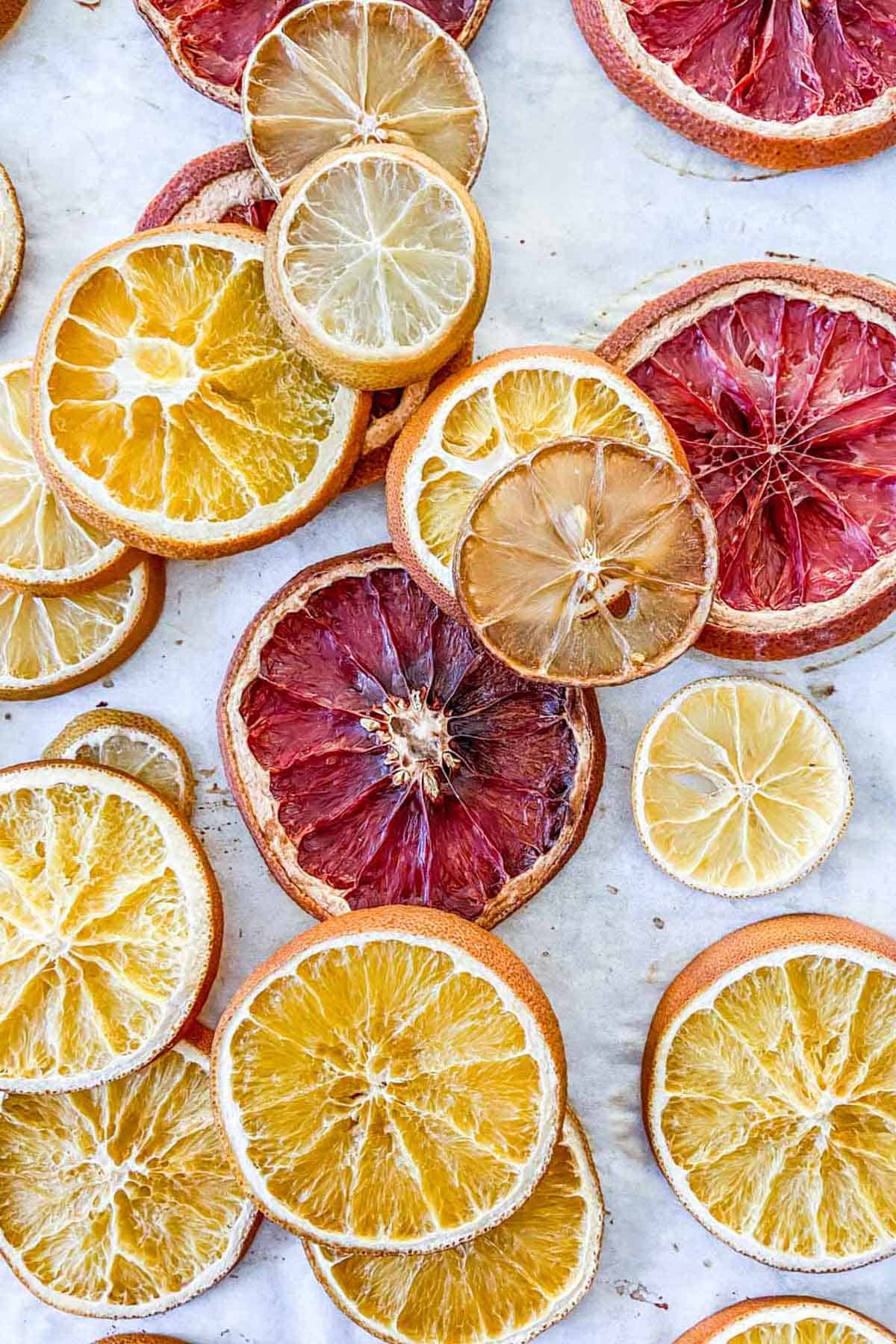 A grouping of dried oranges slices and citrus fruits.