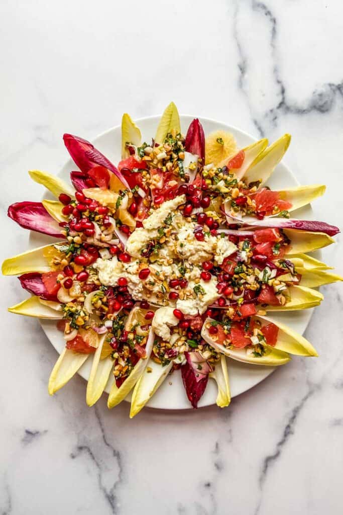 endive salad bites with grilled feta on a white plate